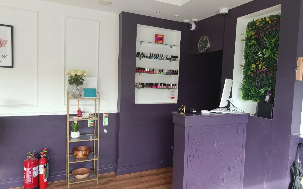 The front desk and plant wall at Plum Nail Bar