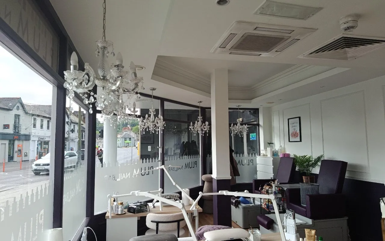Window seats and chandeliers inside Plum Nail Bar, Douglas